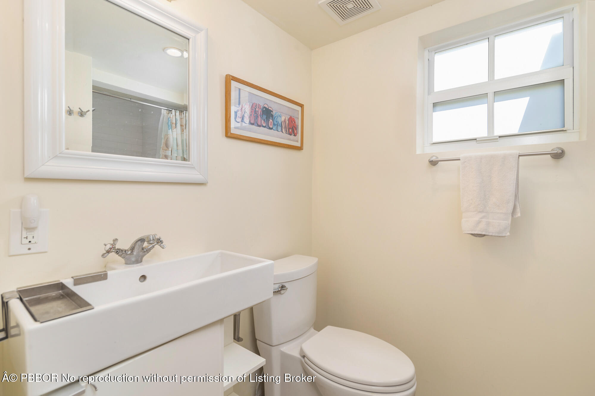 714 Sunset Road West Palm Beach, FL 33401 - Photo 16 of 18 a white toilet sitting next to a bathroom sink