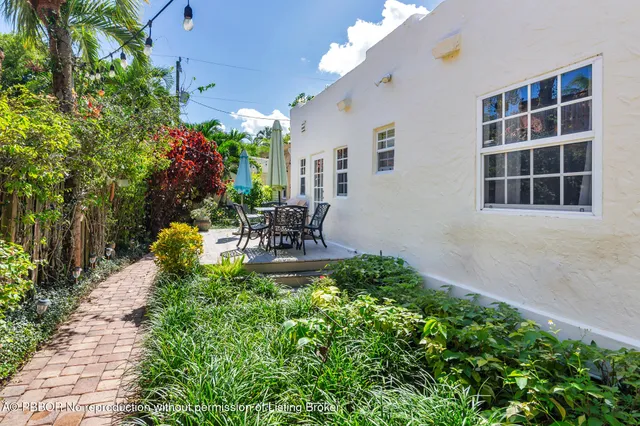 a view of a house with sitting area and garden