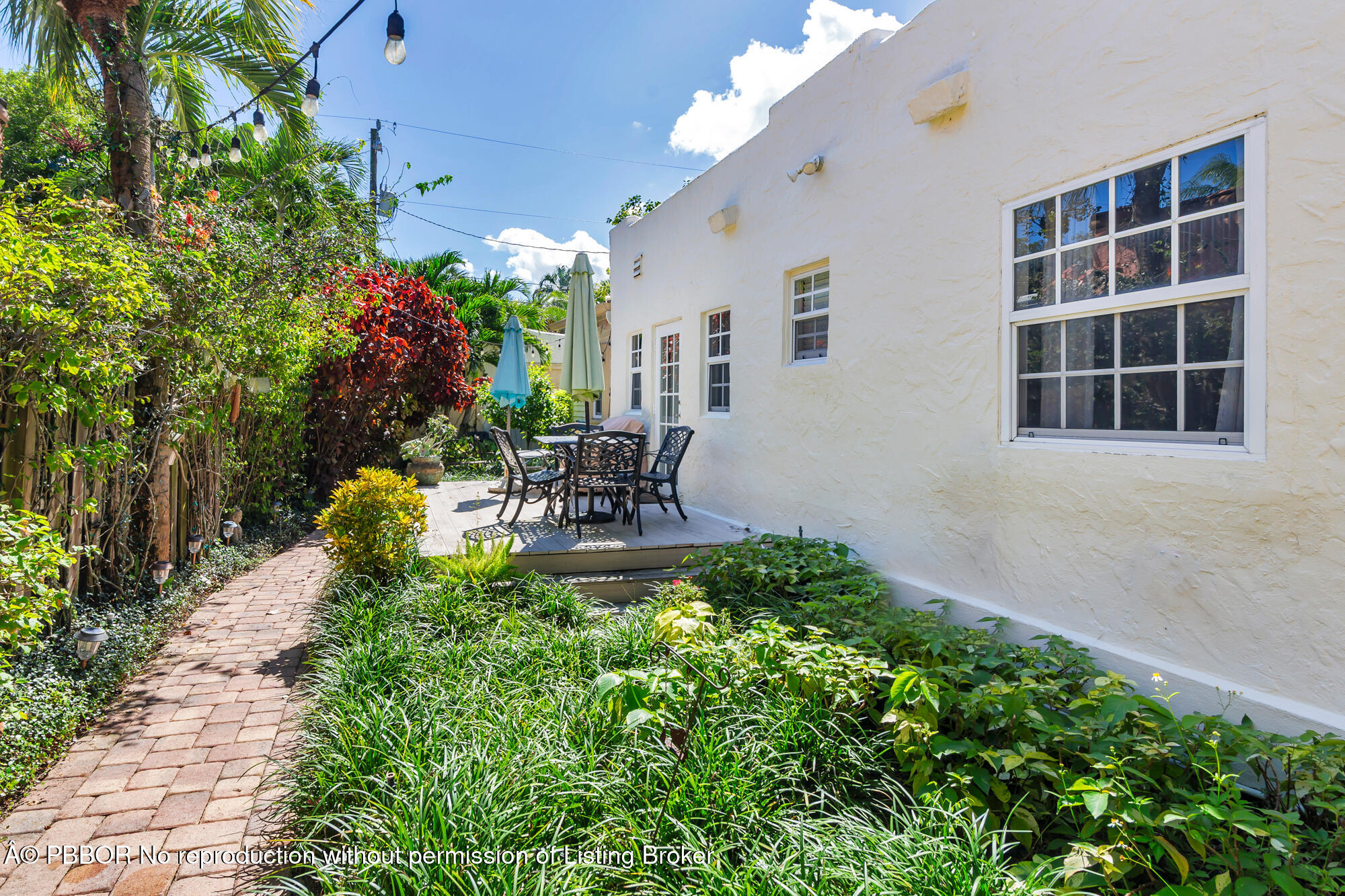 714 Sunset Road West Palm Beach, FL 33401 - Photo 17 of 18 a view of a house with sitting area and garden