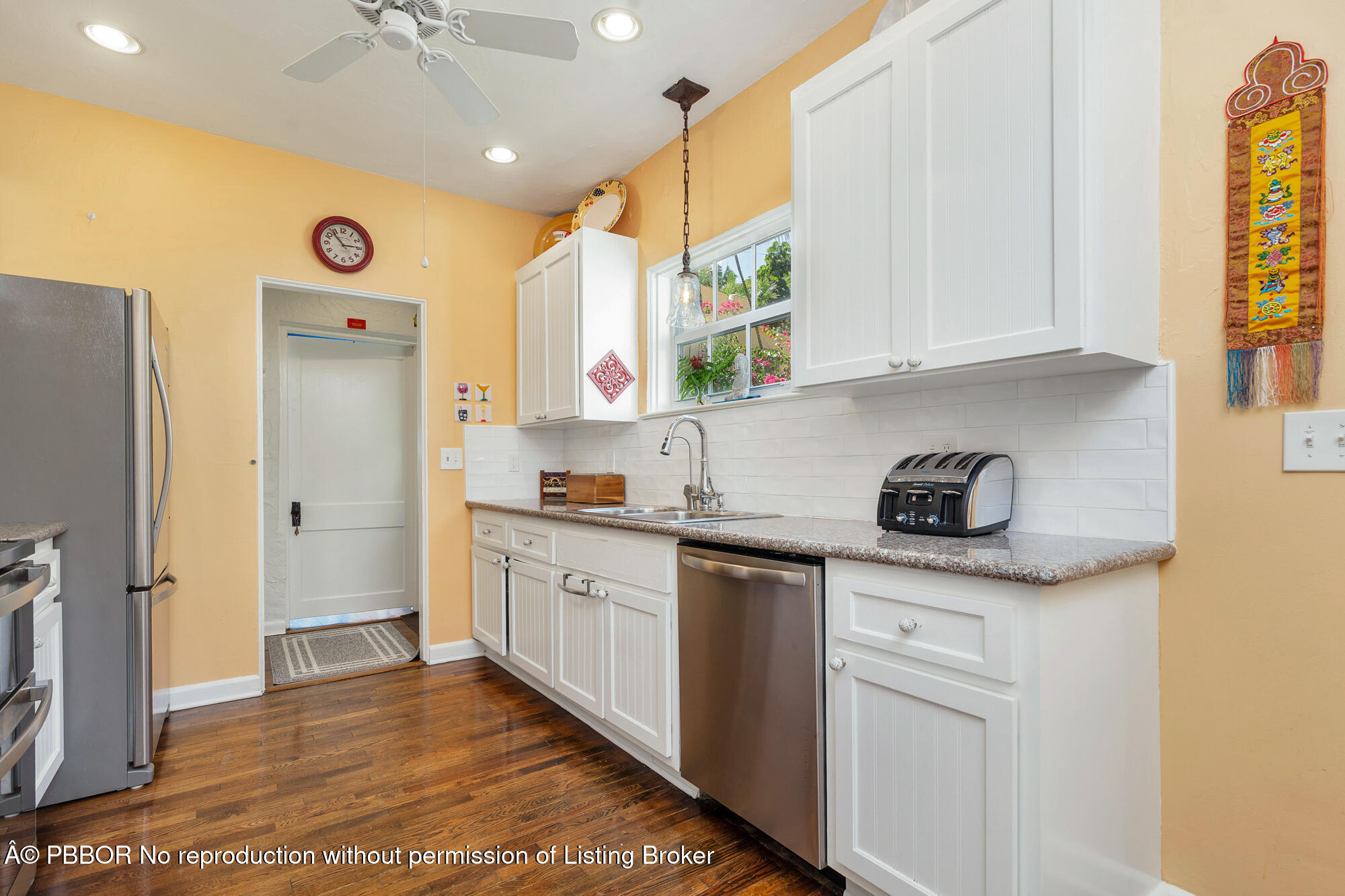 714 Sunset Road West Palm Beach, FL 33401 - Photo 7 of 18 a kitchen with stainless steel appliances granite countertop a sink and cabinets