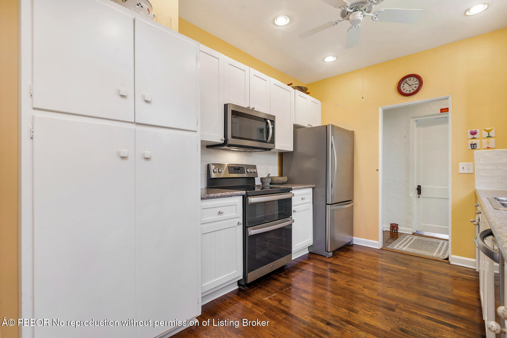 714 Sunset Road West Palm Beach, FL 33401 - Photo 8 of 18 a kitchen with a refrigerator and a stove