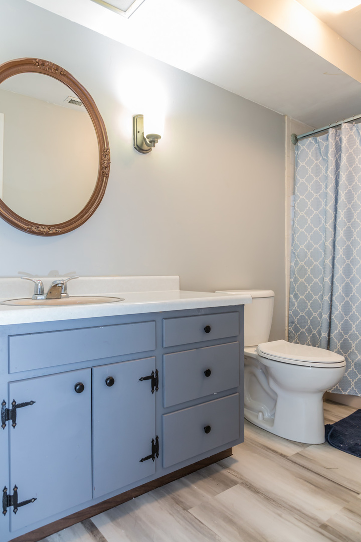 4N726 Klein Road West Chicago, IL 60185 - Photo 16 of 25 a bathroom with a toilet a sink a mirror and bathtub