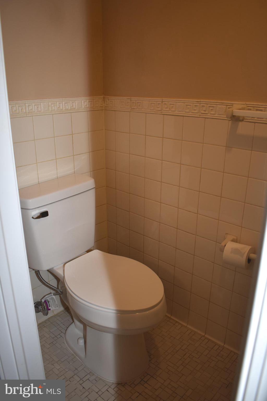 12176 Dove Circle Laurel, MD 20708 - Photo 15 of 34 a white toilet sitting next to a white sink and vanity