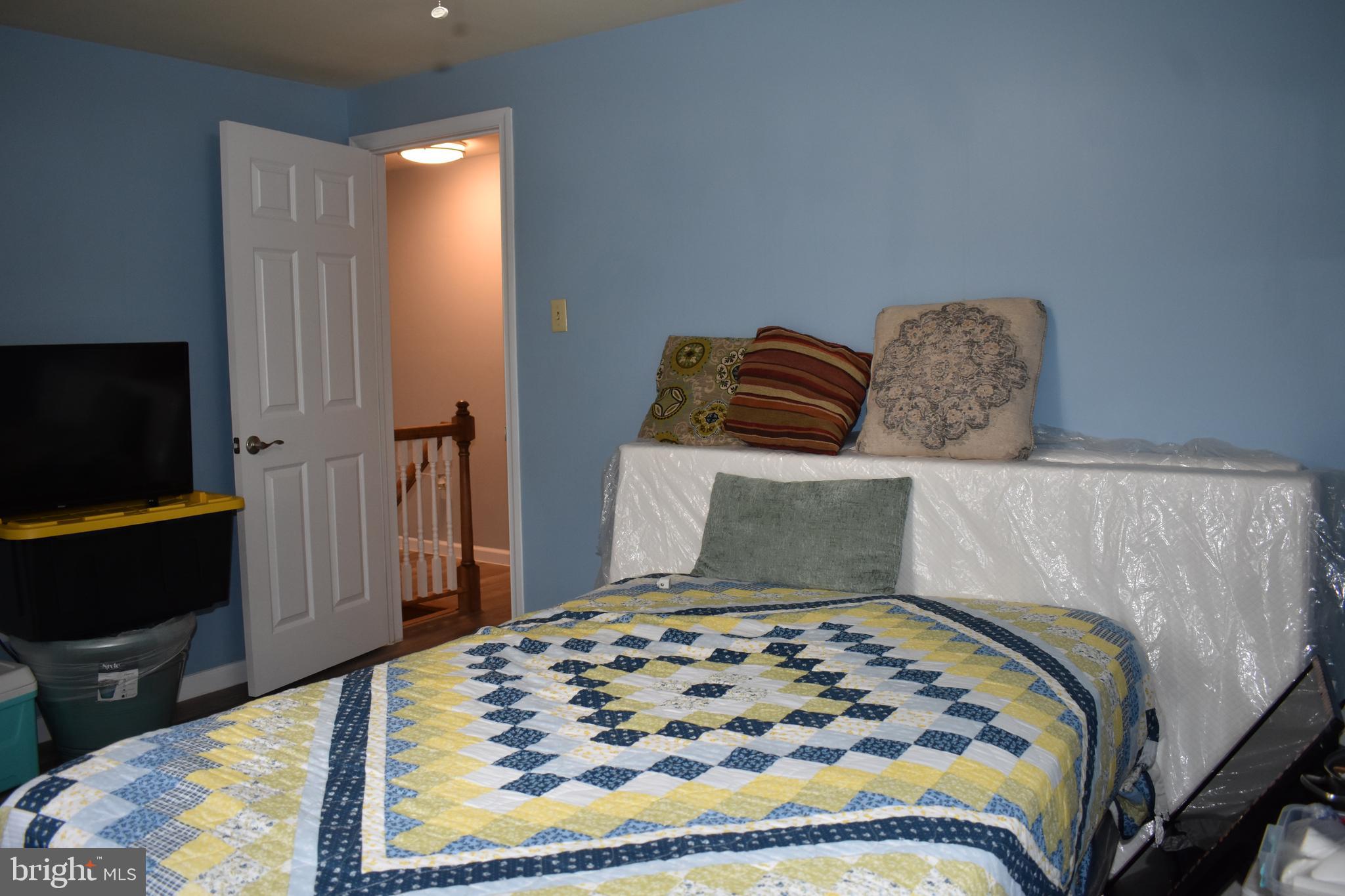 12176 Dove Circle Laurel, MD 20708 - Photo 17 of 34 a bedroom with a bed and wooden floor