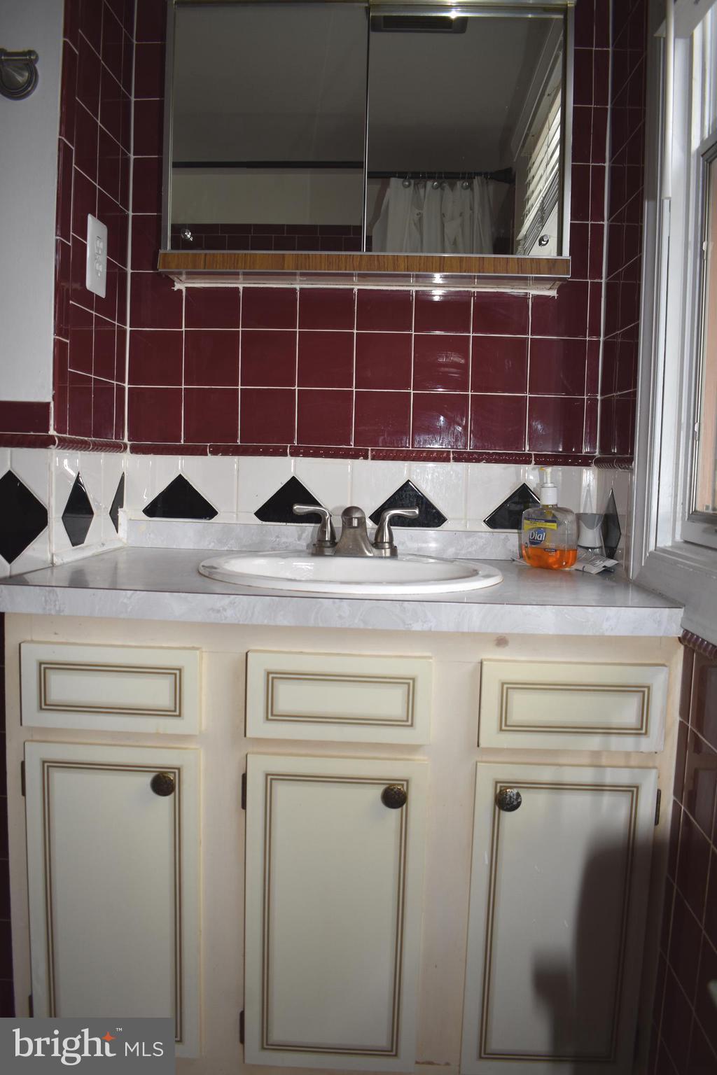 12176 Dove Circle Laurel, MD 20708 - Photo 21 of 34 a bathroom with a sink and a mirror