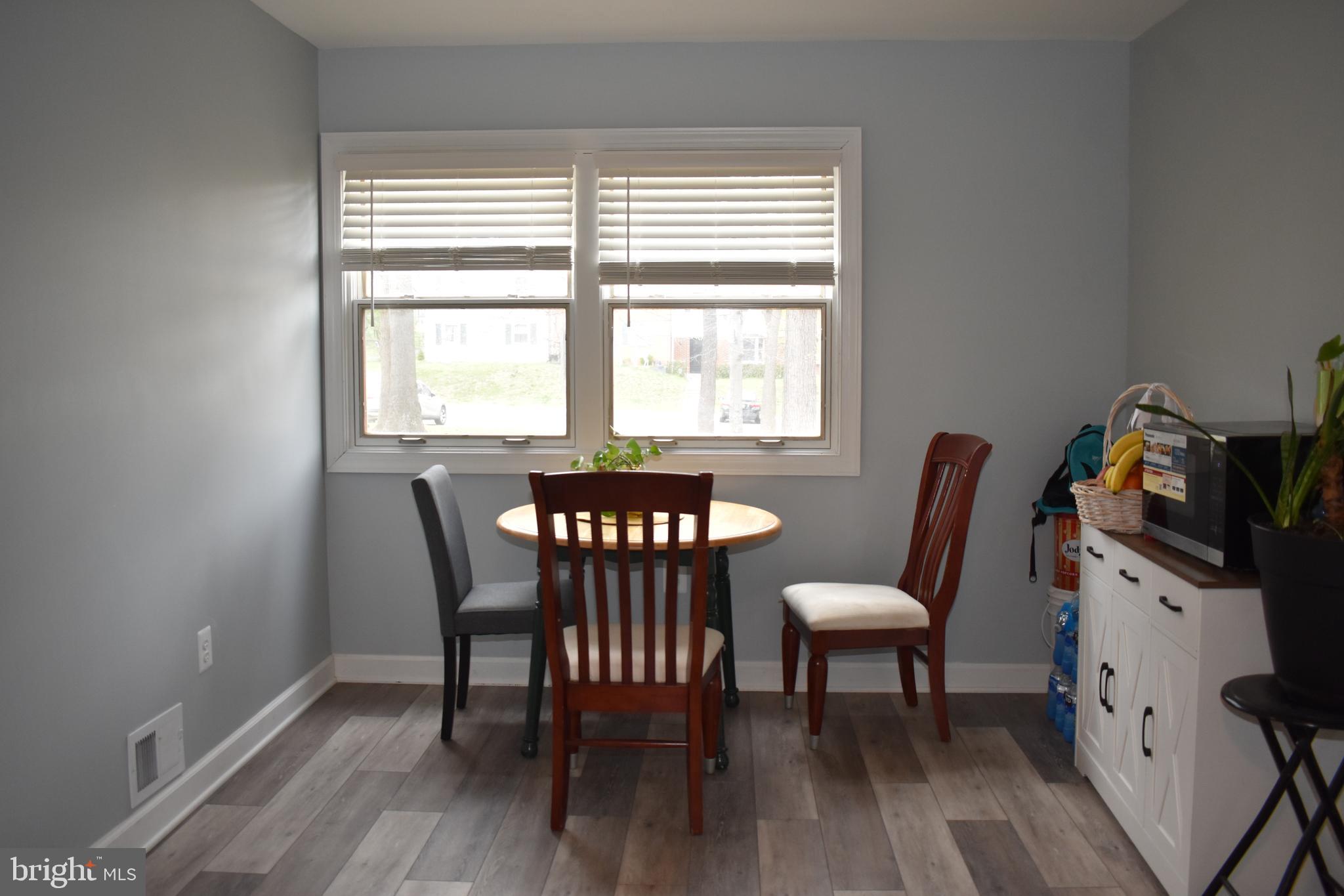 12176 Dove Circle Laurel, MD 20708 - Photo 9 of 34 a view of a dining room with furniture a rug and wooden floor