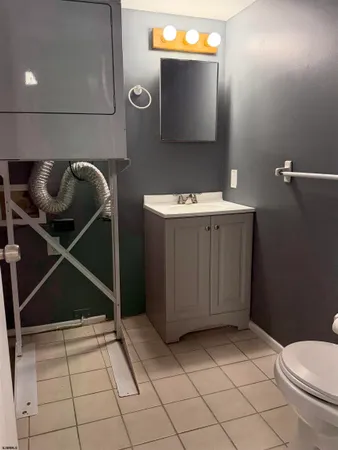 a bathroom with a sink toilet and mirror