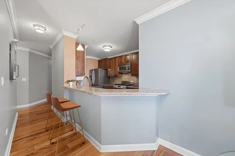 a kitchen with stainless steel appliances granite countertop a sink and a stove