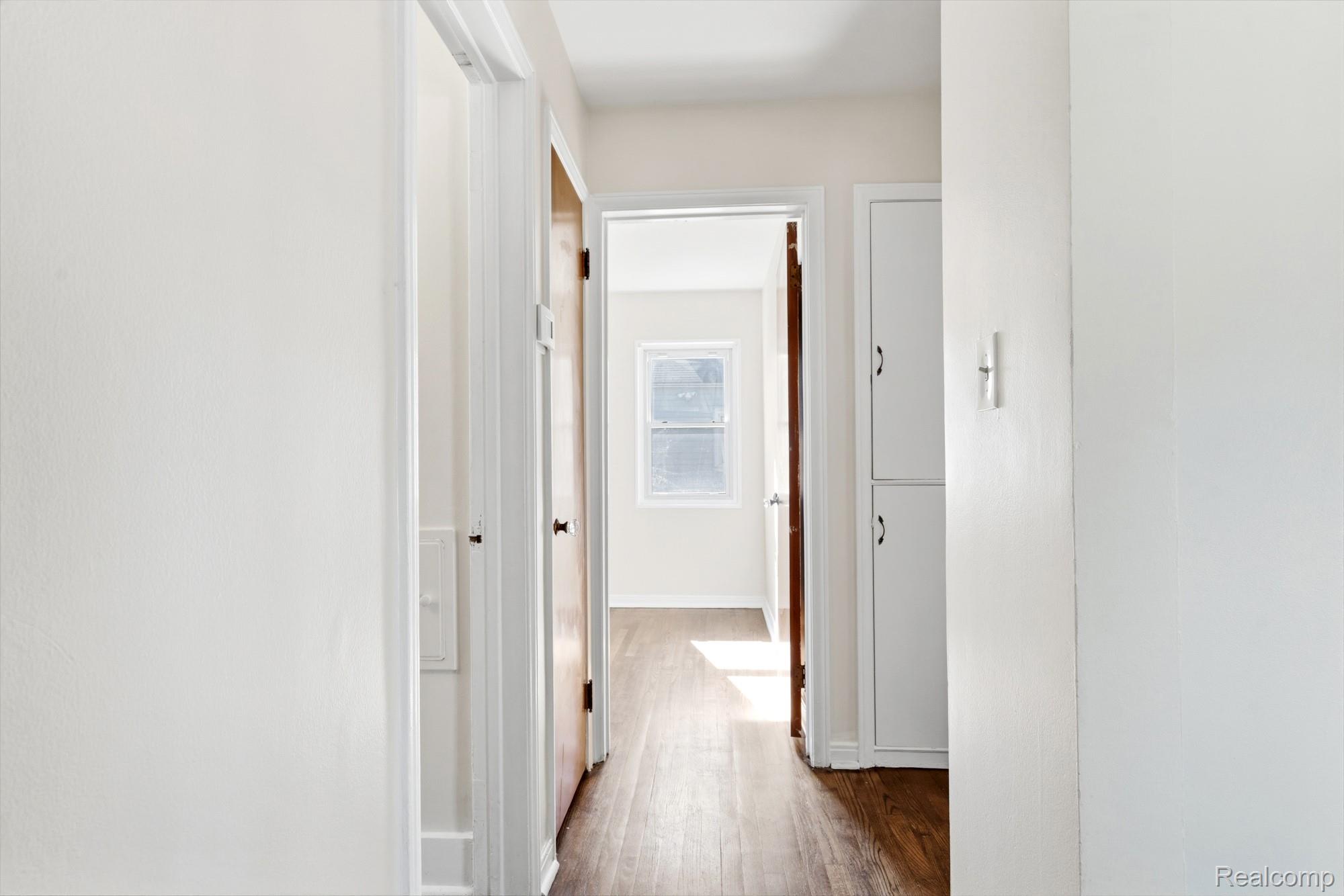 970 Champaign Road Lincoln Park, MI 48146 - Photo 24 of 28 Corridor with dark wood-style flooring and baseboards
