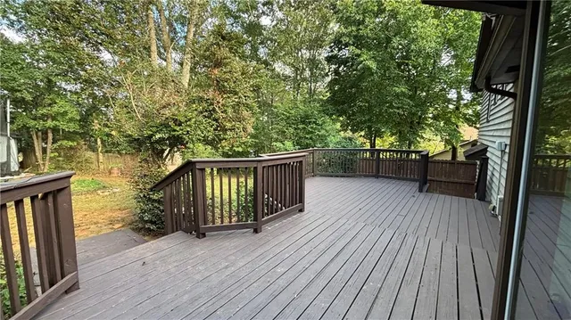 a view of balcony with wooden floor and outdoor seating