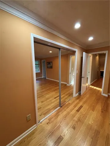 a view of empty room with wooden floor