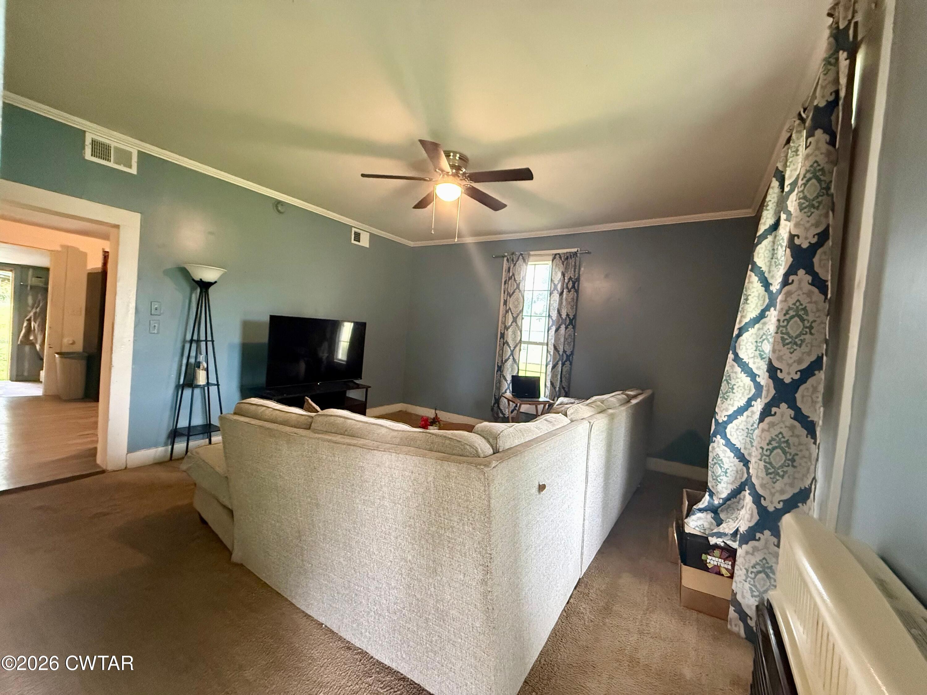 1935 Buster Collins Road Kenton, TN 38233 - Photo 2 of 18 a living room with a couch and a flat screen tv
