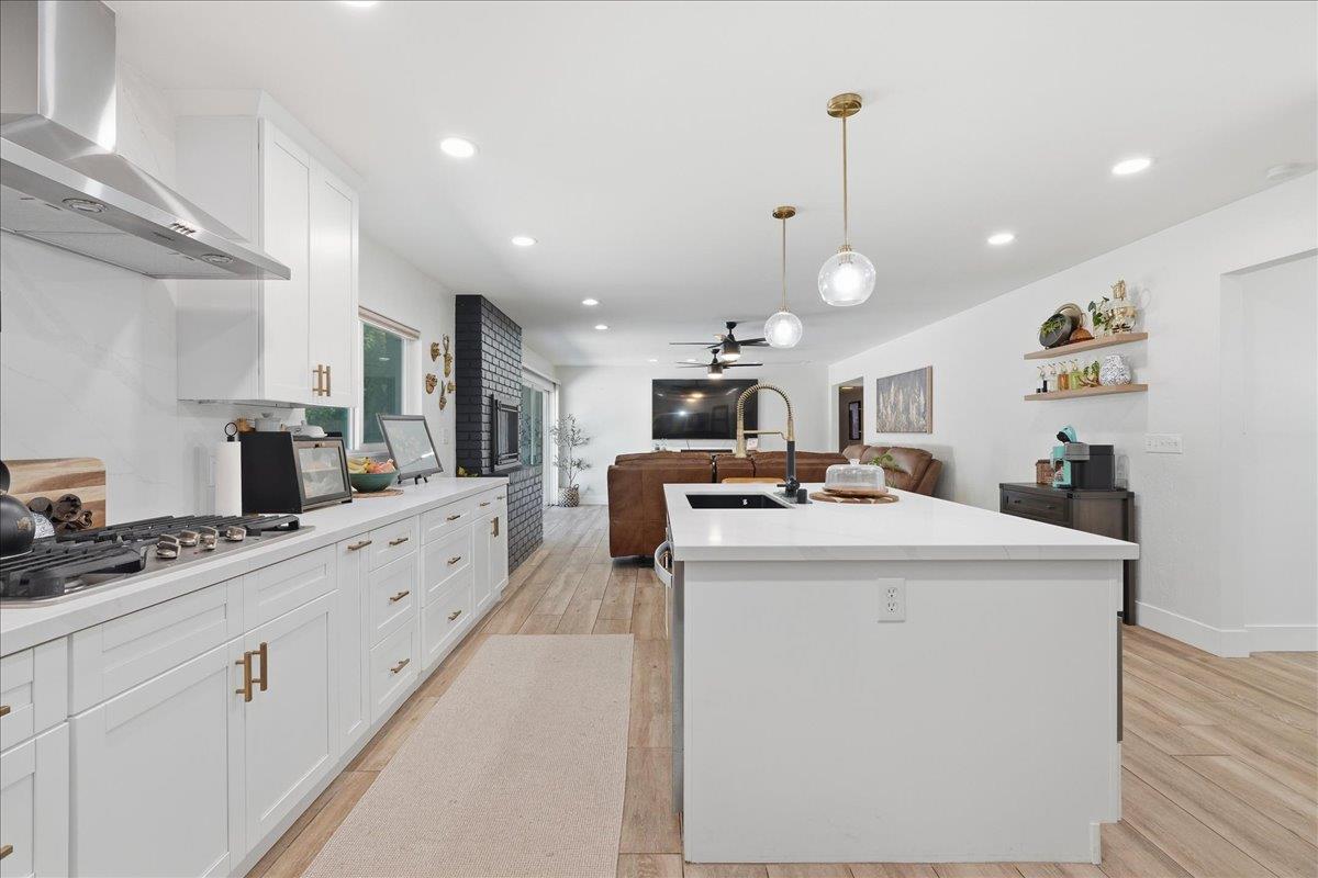 4849 Alexon Way Carmichael, CA 95608 - Photo 19 of 50 a kitchen with stainless steel appliances kitchen island granite countertop a sink and a refrigerator