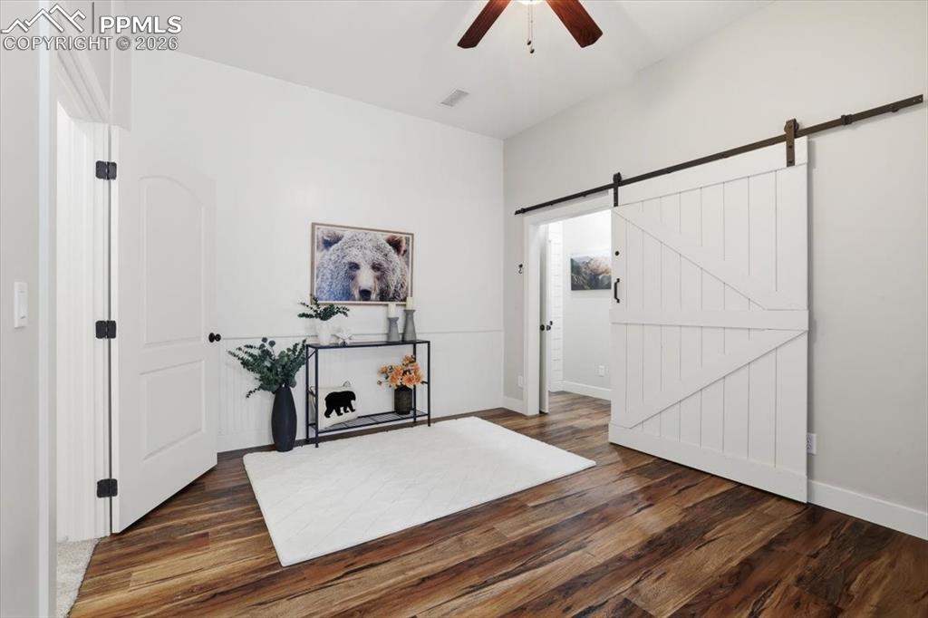 15755 Fool's Gold Lane Colorado Springs, CO 80921 - Photo 32 of 50 a room with gym equipment and wooden floor