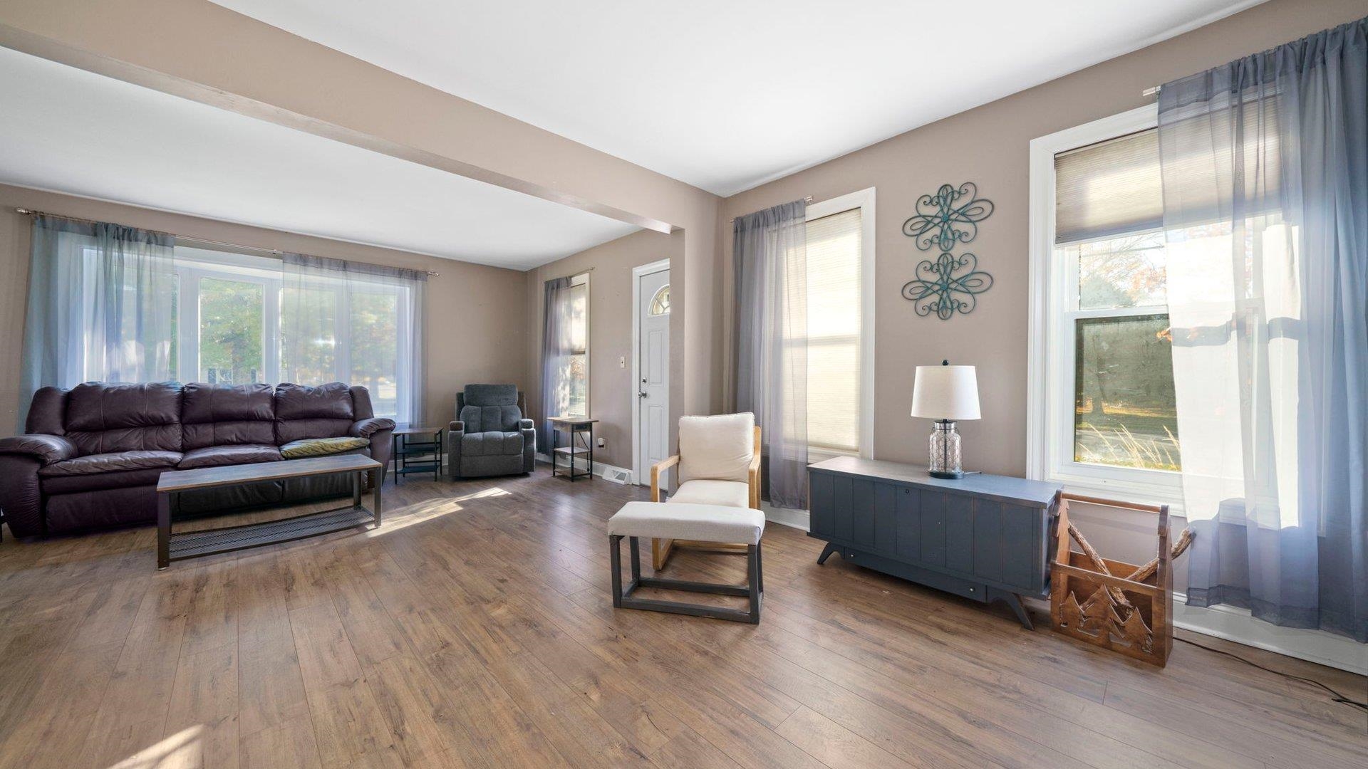 401 West 3rd Street Byron, IL 61010 - Photo 11 of 43 a living room with furniture and a wooden floor