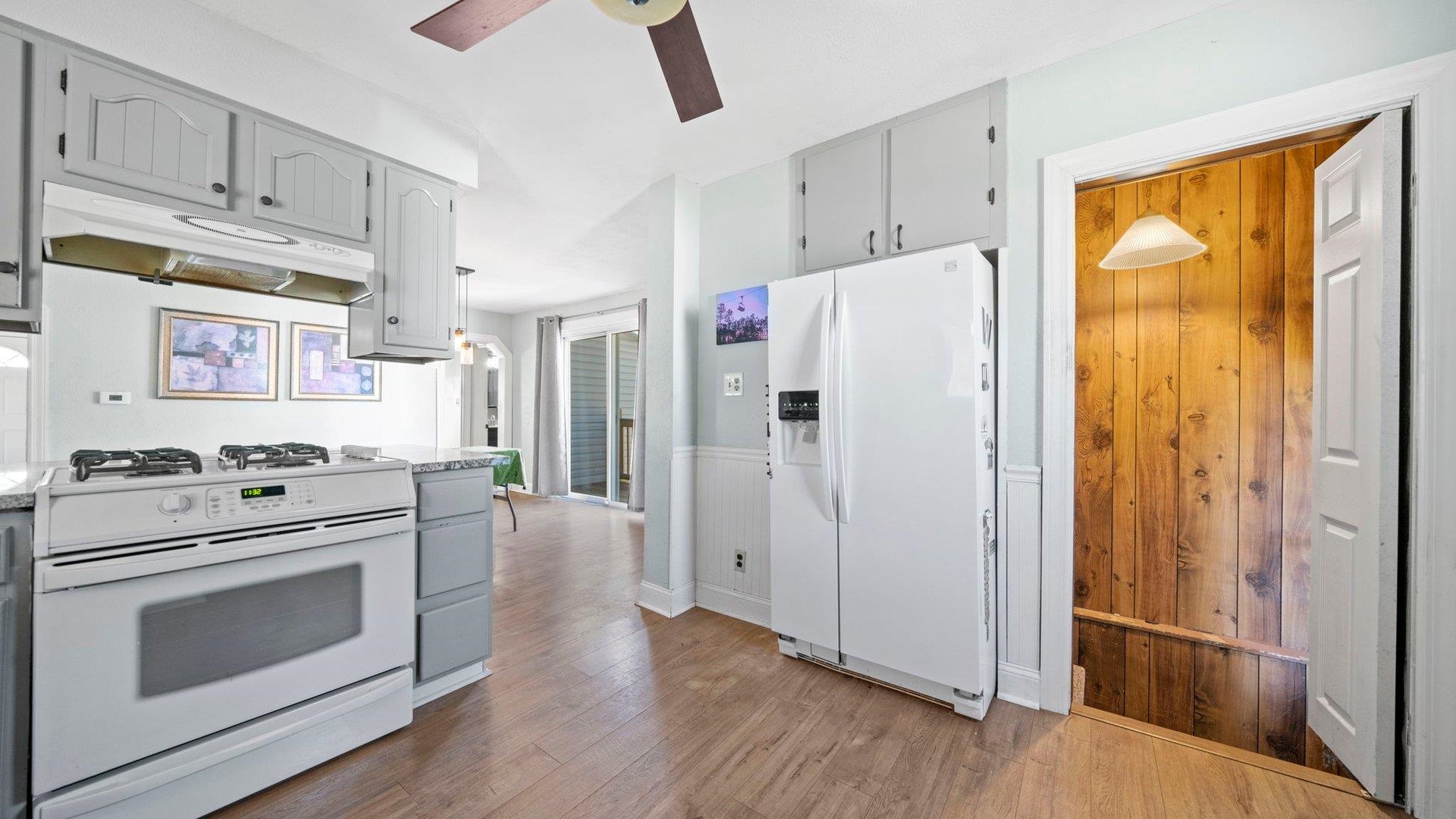 401 West 3rd Street Byron, IL 61010 - Photo 22 of 43 a white refrigerator freezer and a wooden floor