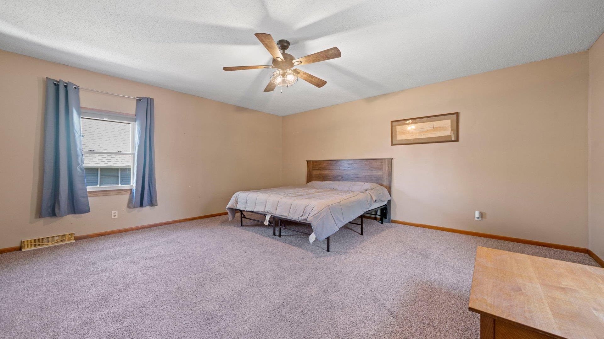 401 West 3rd Street Byron, IL 61010 - Photo 24 of 43 a bed room with a bed and window