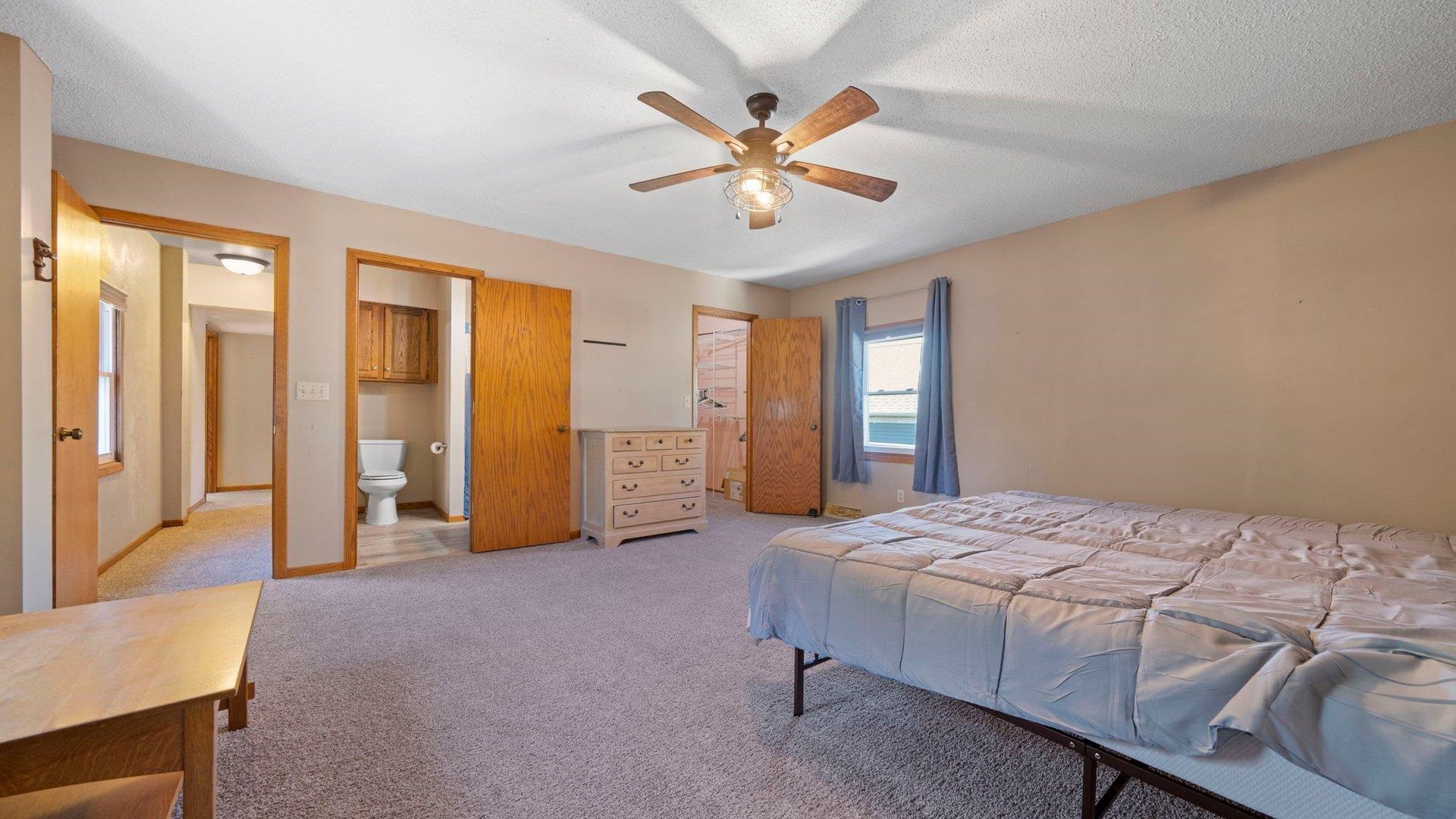401 West 3rd Street Byron, IL 61010 - Photo 25 of 43 a bed room with a bed and a chandelier