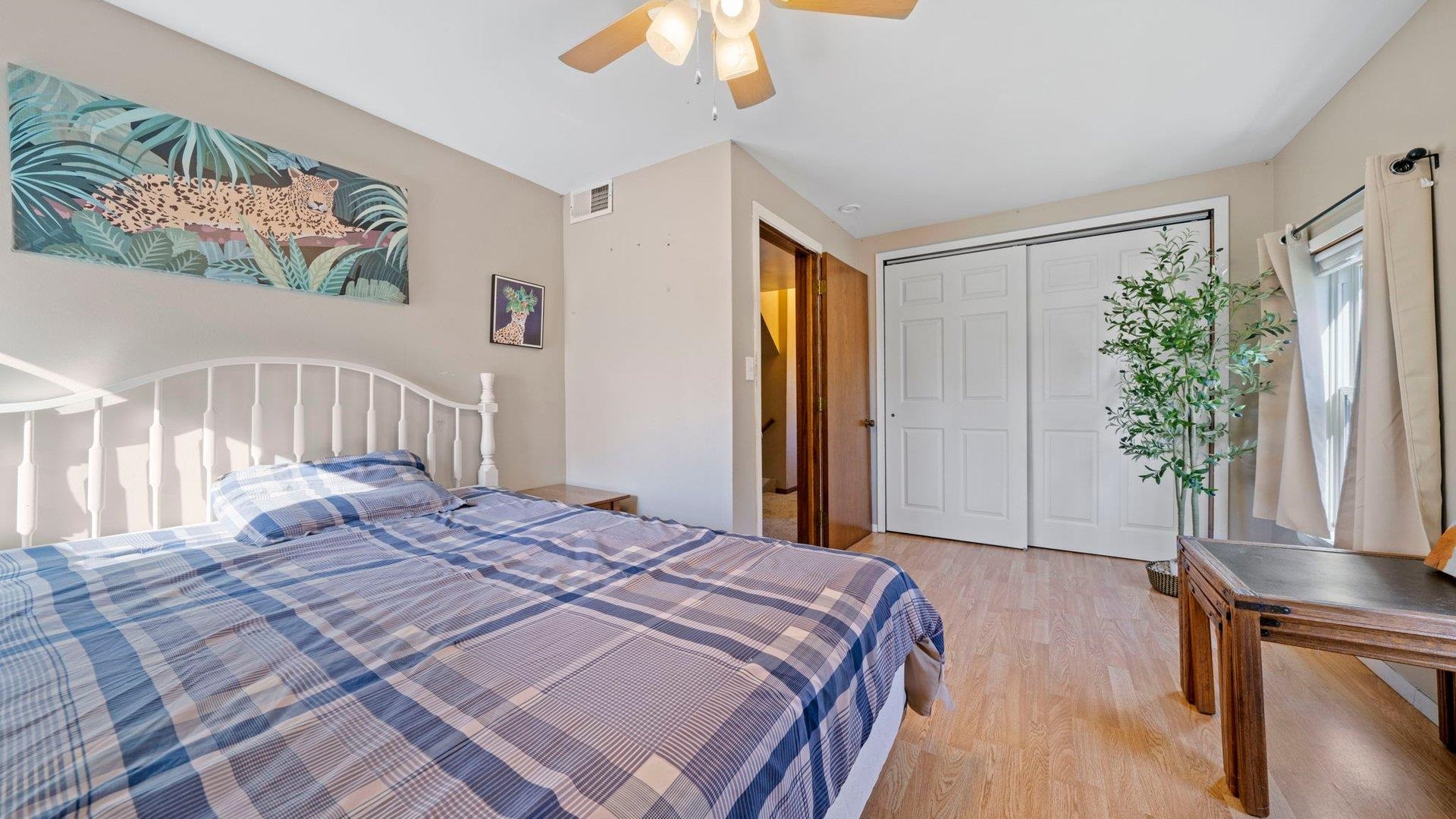 401 West 3rd Street Byron, IL 61010 - Photo 28 of 43 a bedroom with a bed and a potted plant