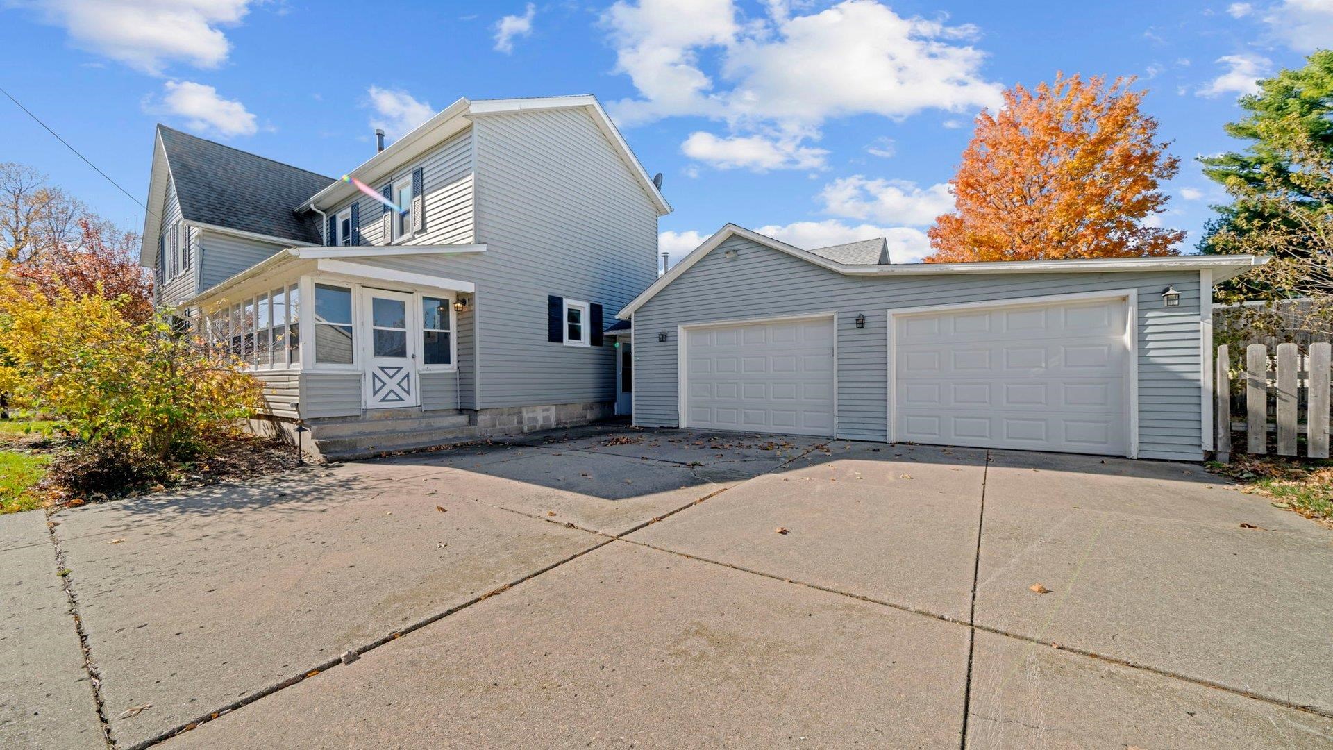 401 West 3rd Street Byron, IL 61010 - Photo 35 of 43 a front view of a house with a yard and garage