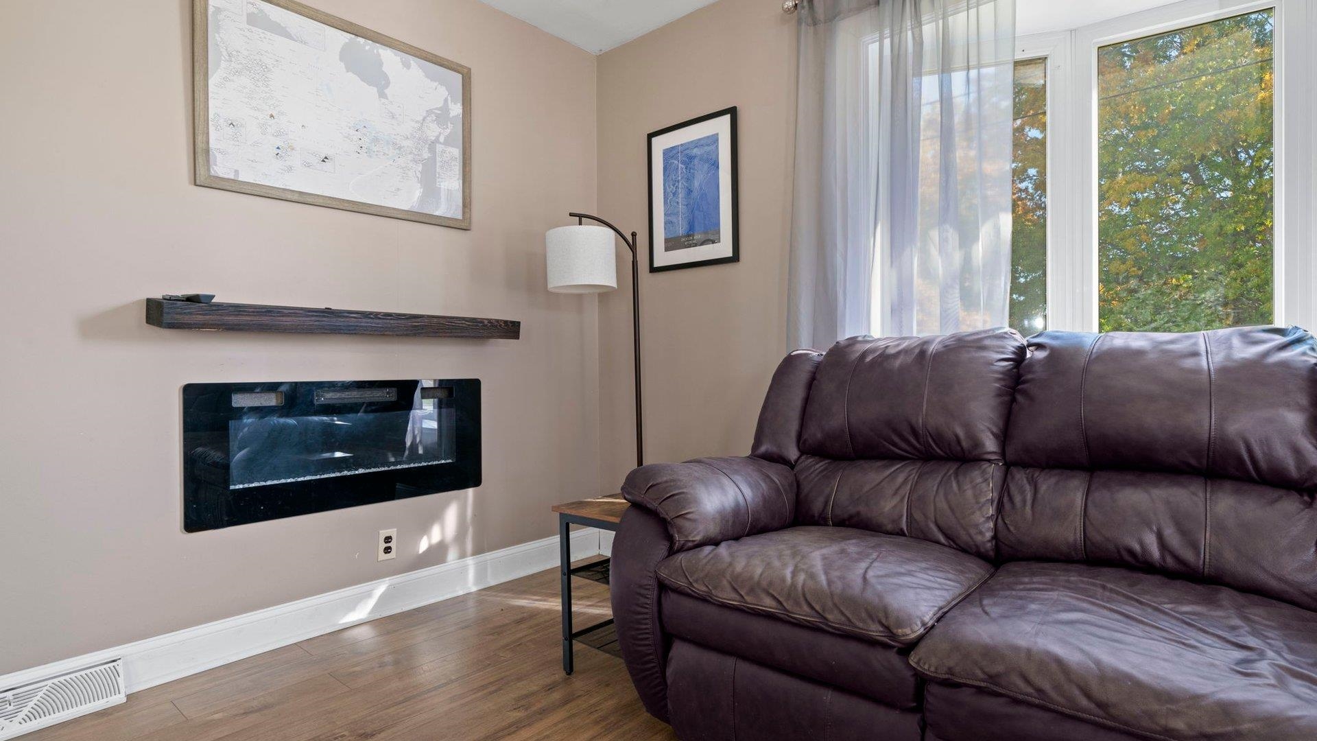 401 West 3rd Street Byron, IL 61010 - Photo 8 of 43 a living room with furniture and a fireplace