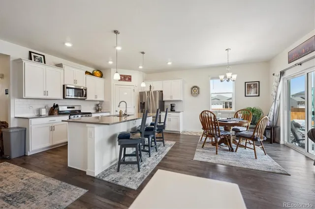 a dining room with furniture and wooden floor