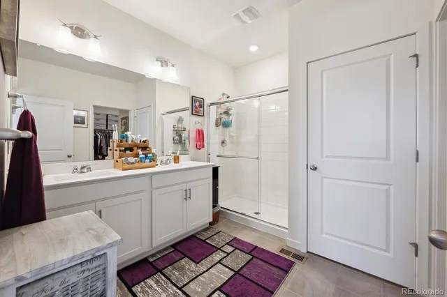 a view of walk in closet with clothes