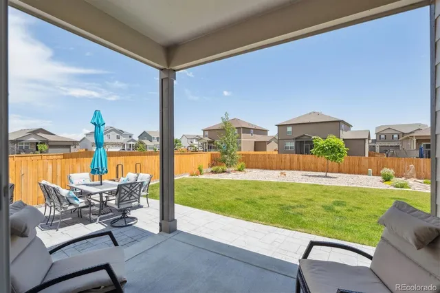 a swimming pool with outdoor seating and yard