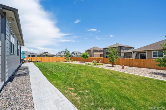 a view of a backyard both side of the house