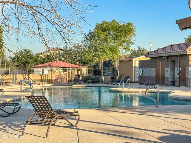 a view of a swimming pool with lounge chairs