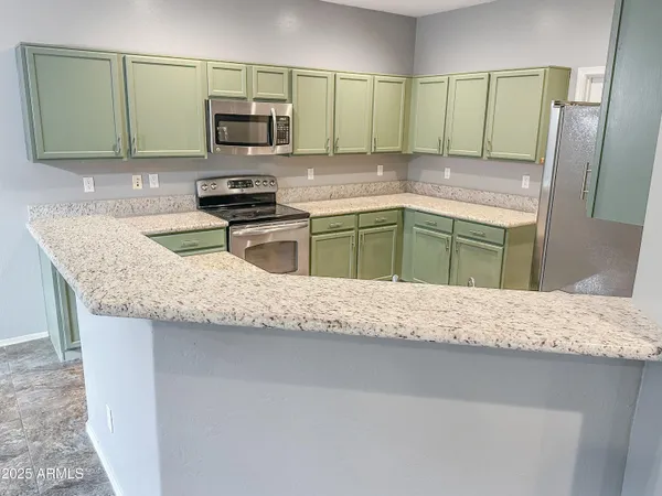 a kitchen with granite countertop a sink and a stove top oven
