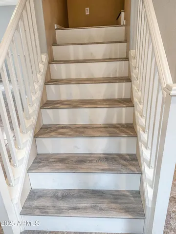 a view of staircase with white walls