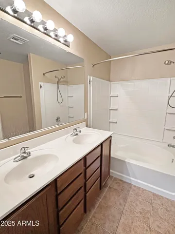 a bathroom with a sink mirror and a shower