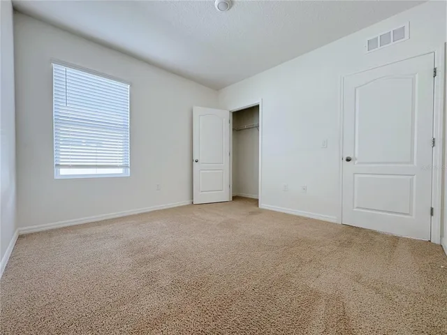 a kitchen with granite countertop a refrigerator and a stove top oven