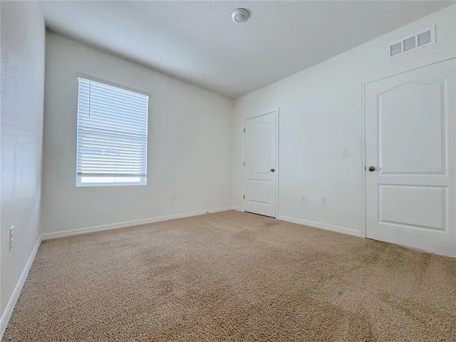 a kitchen with granite countertop a refrigerator and a stove top oven