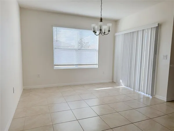 a view of a kitchen with furniture and an empty room
