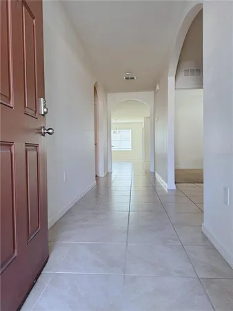 a view of a hallway to rooms