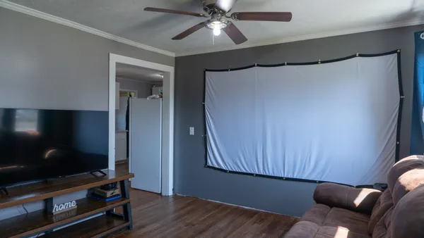 a roof deck with table and chairs and potted plants