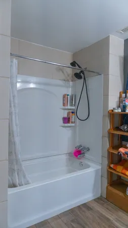 a kitchen with a refrigerator a sink and dishwasher with white cabinets