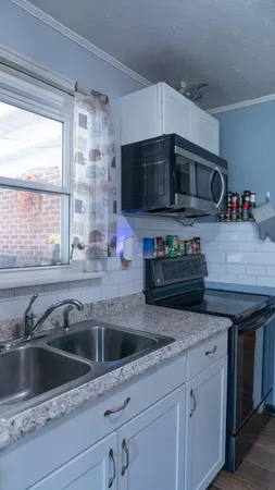 a bathroom with a toilet sink vanity and mirror