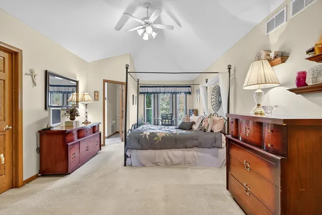 a bedroom with a large bed and a chandelier