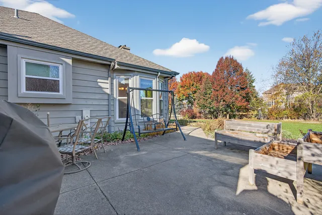 a view of a patio with couches and table and chairs and potted plants
