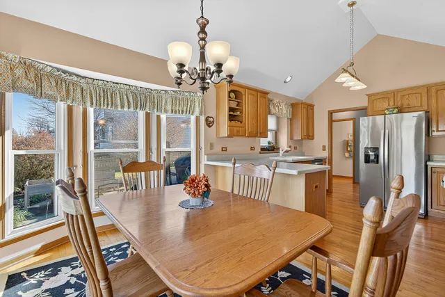 a view of a dining room with furniture a chandelier and wooden floor
