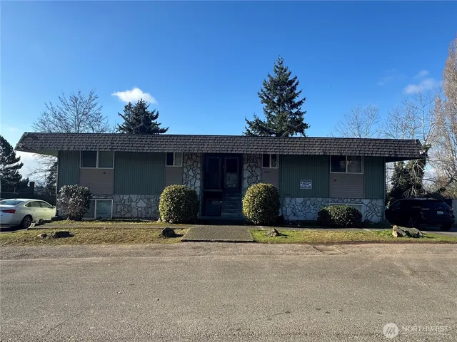 a view of a house with a yard and garage