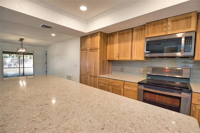 a kitchen with stainless steel appliances a stove sink microwave and cabinets