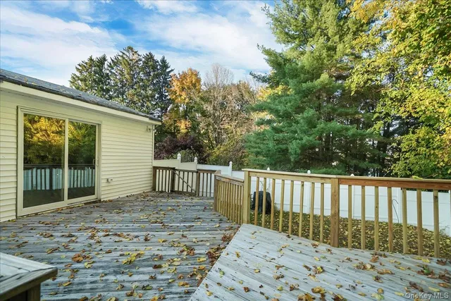 a balcony with wooden floor and fence