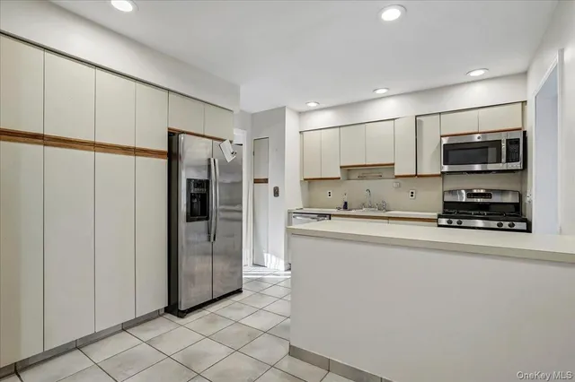 a view of a kitchen with a sink dishwasher and a refrigerator