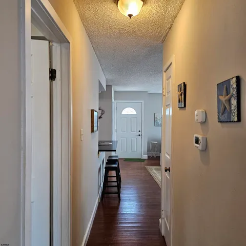 a view of a hallway with a hardwood floor