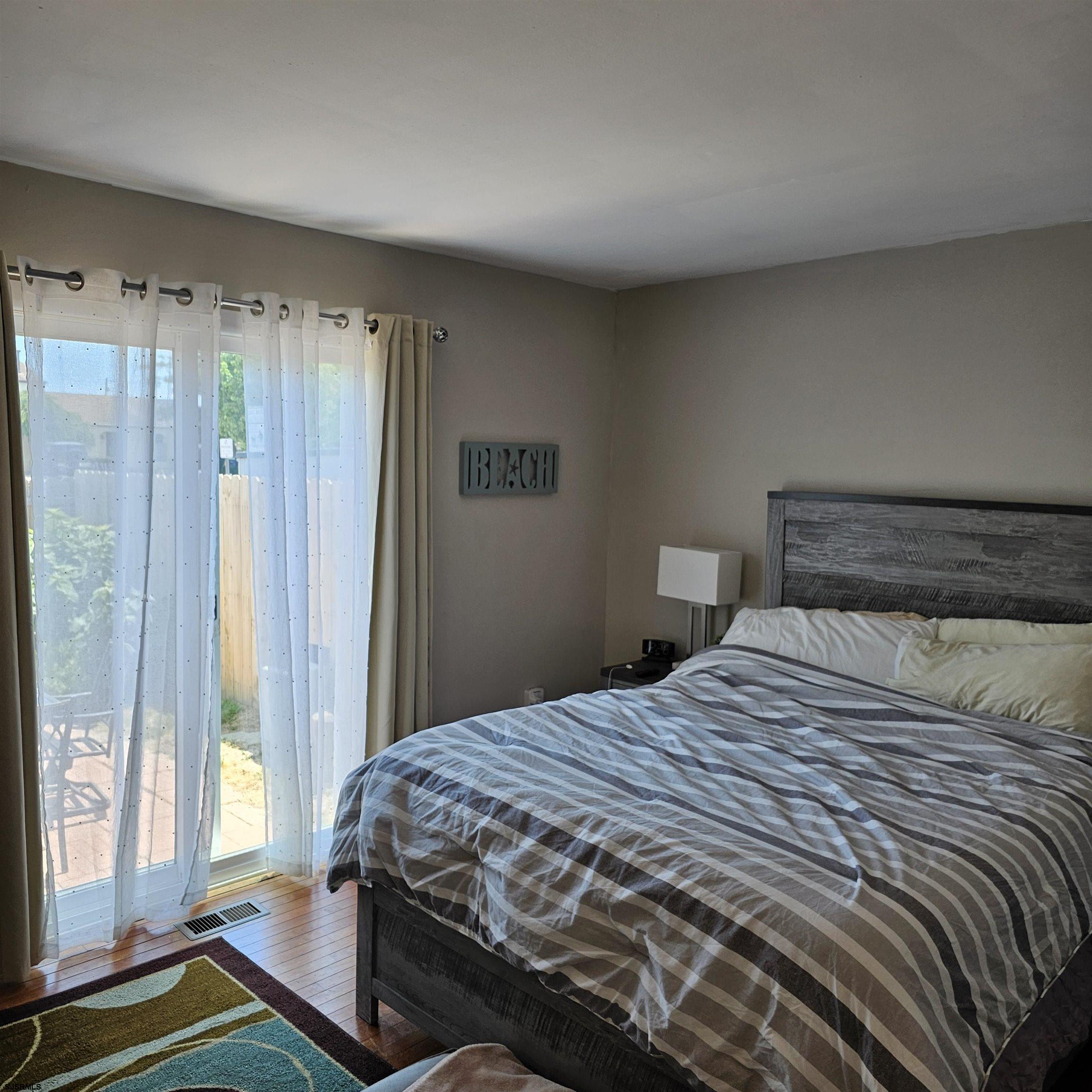 518 Casa Drive, Unit SUMMER RENTAL Brigantine, NJ 08203 - Photo 13 of 19 a bedroom with a bed and a window