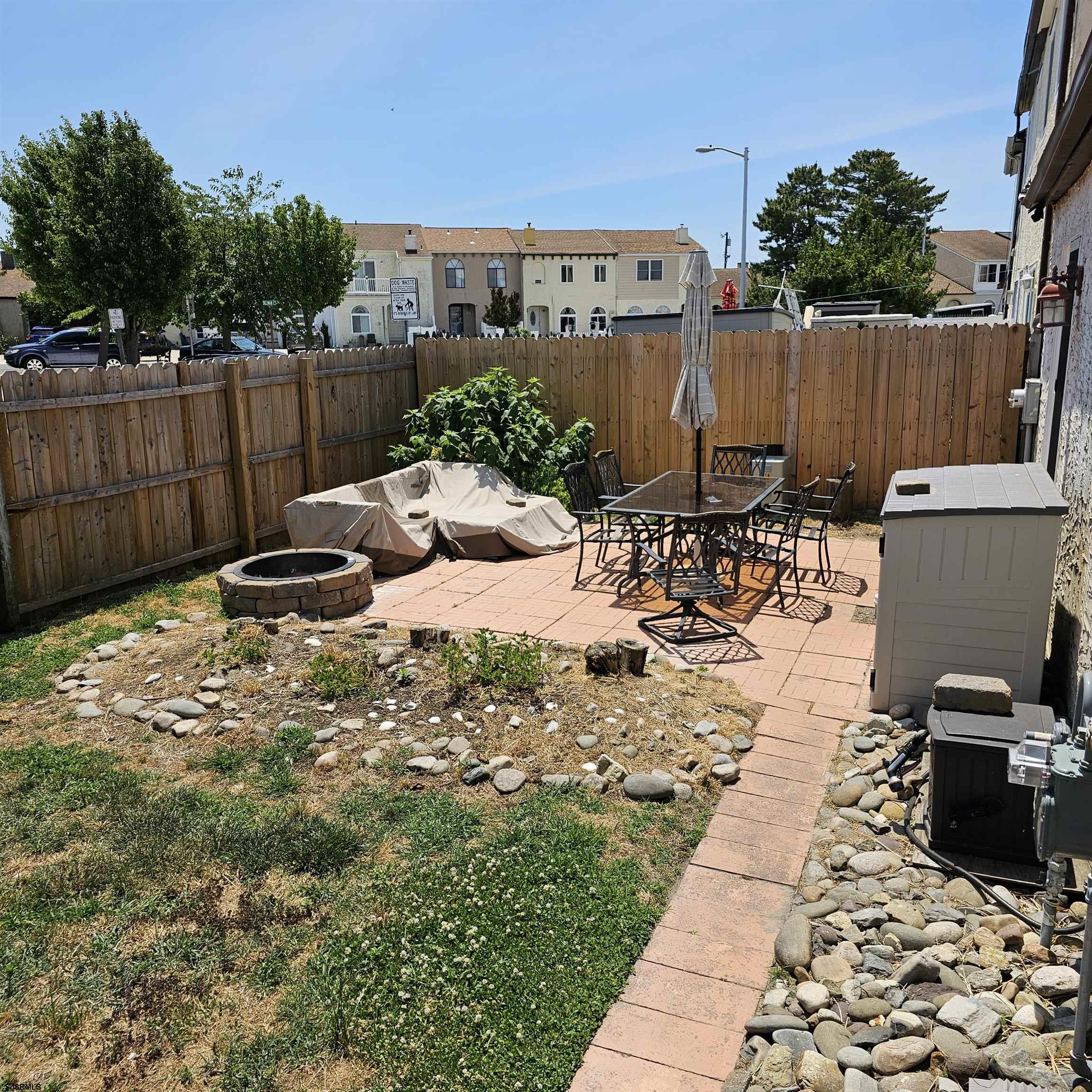 518 Casa Drive, Unit SUMMER RENTAL Brigantine, NJ 08203 - Photo 18 of 19 a view of a backyard with sitting area